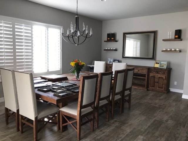 A dining room with a table and chairs and a chandelier