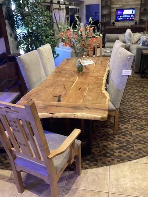 A wooden table and chairs in a dining room