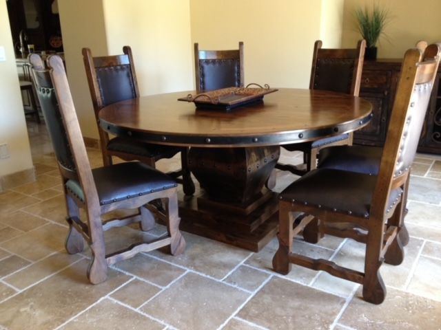 A dining room table with four chairs and a tray on top