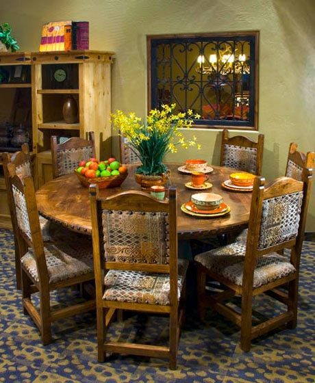 A dining room with a round table and chairs