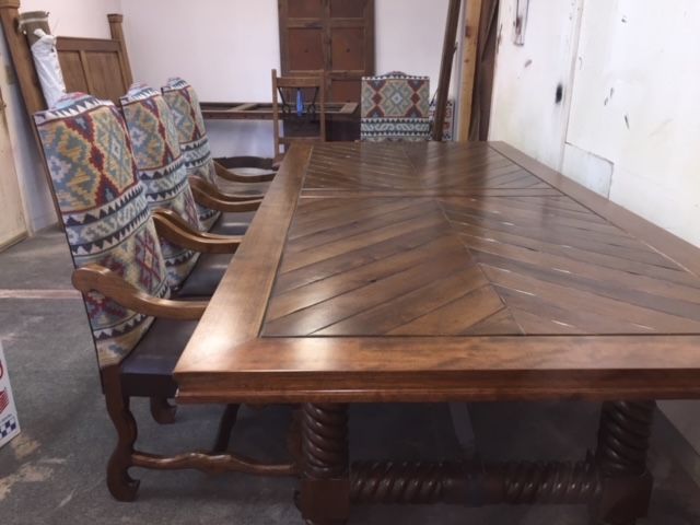 A wooden dining table and chairs in a room