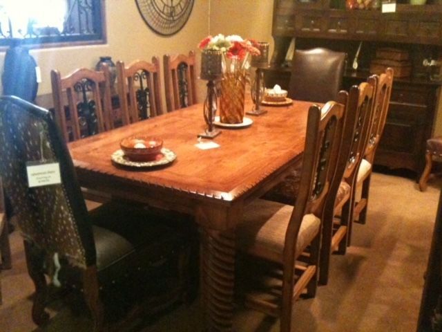 A dining room table with plates and candles on it