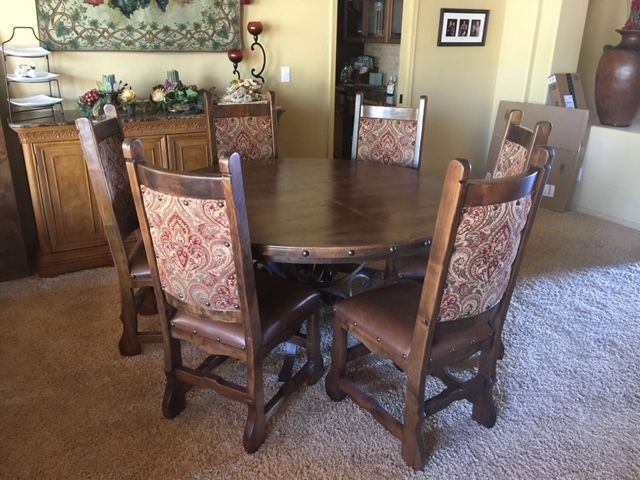 A dining room table and chairs in a dining room