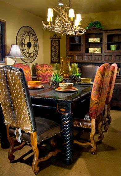 A dining room with a table and chairs and a clock on the wall