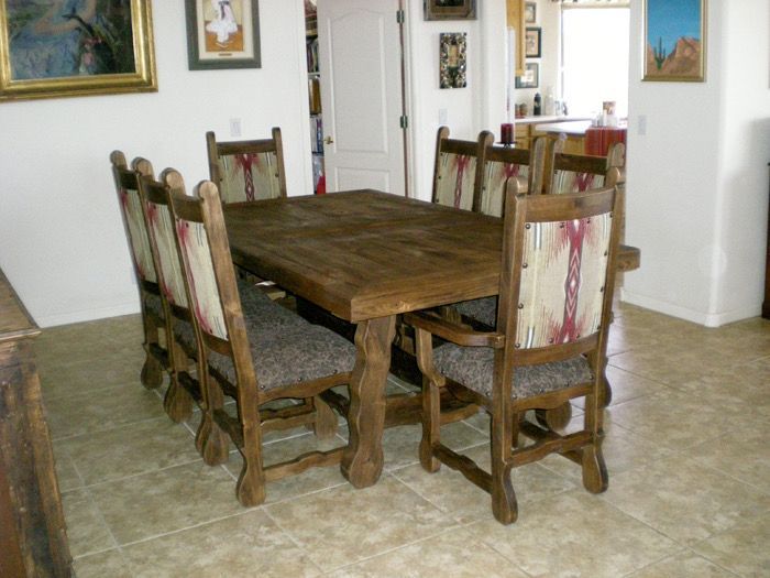 A dining room with a wooden table and chairs