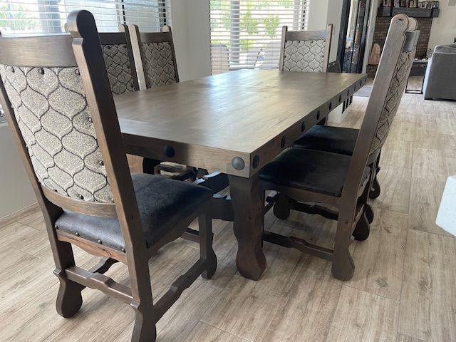 A wooden table and chairs in a dining room