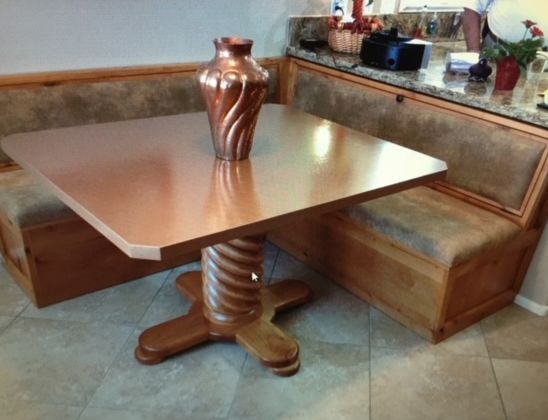 A wooden dining table with a vase on top of it