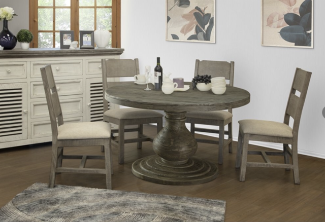 A dining room with a round table and four chairs