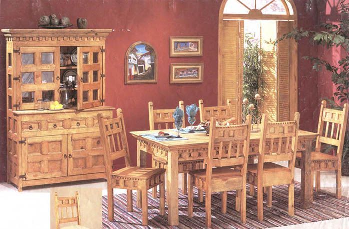 A dining room with a table and chairs and a hutch