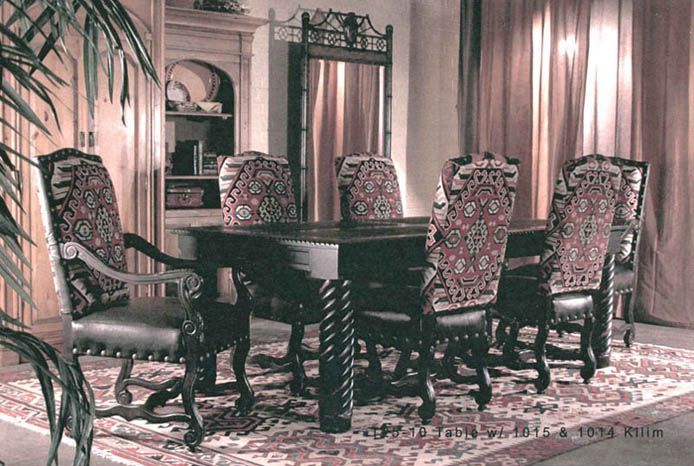 A dining room with a table and chairs and a rug