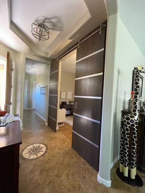 A hallway with sliding doors and a giraffe statue