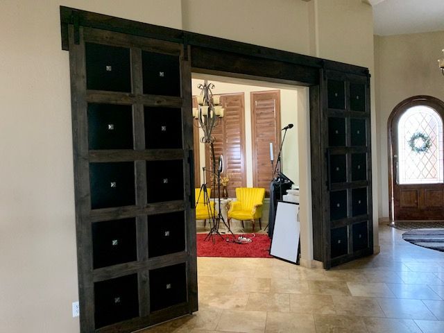 A room with sliding barn doors leading to a living room