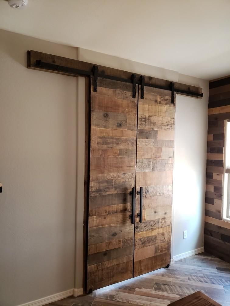 A pair of wooden sliding barn doors in a room