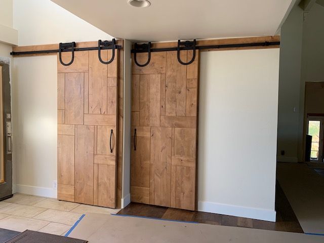A pair of wooden sliding barn doors in a room