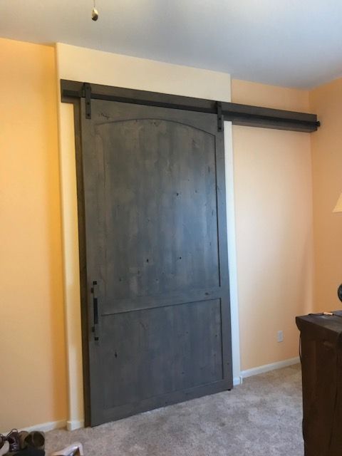 A bedroom with a large sliding barn door