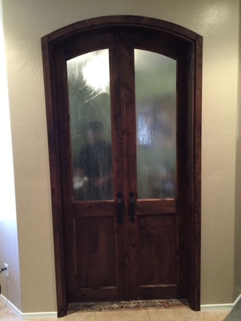 A wooden door with glass