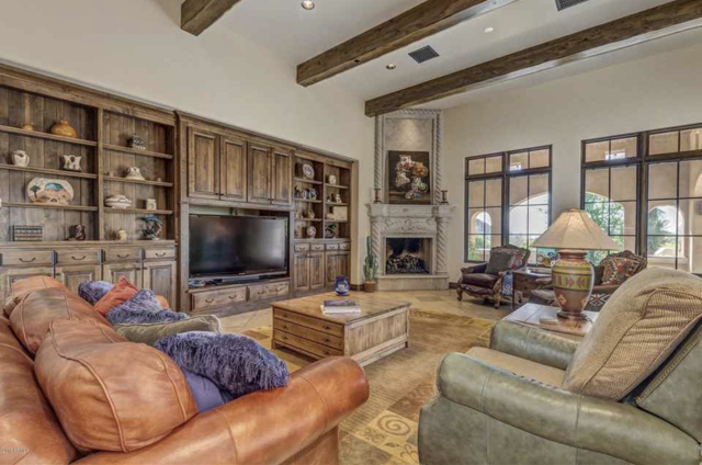 A living room with a custom-made entertainment center, complete with furniture and a television