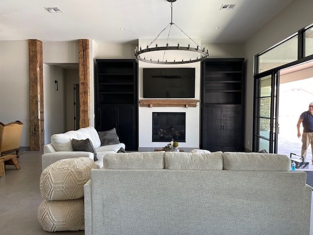 A living room with a couch, fireplace, and television