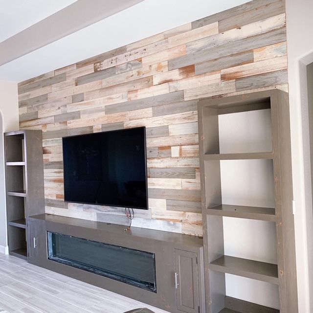 A living room with a wooden wall and a flat screen television
