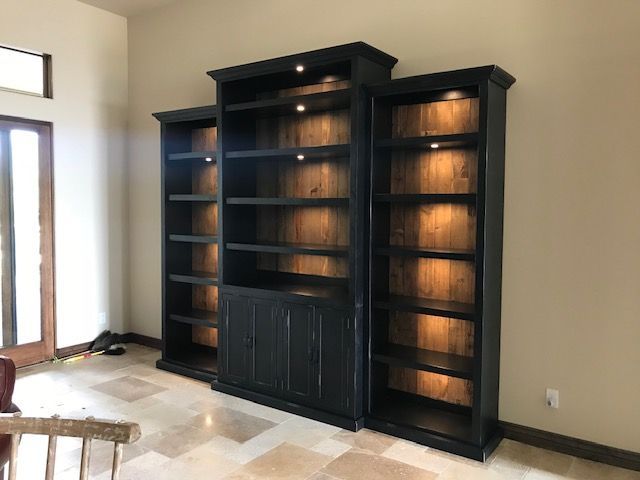 A room with a lot of shelves and a chair