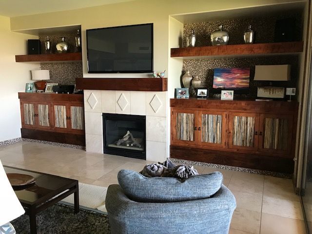 A living room with a fireplace and a flat screen television