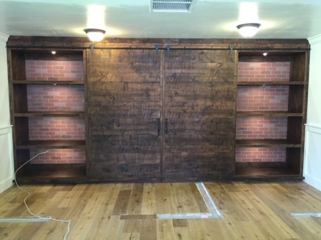 A room with shelves and a sliding barn door