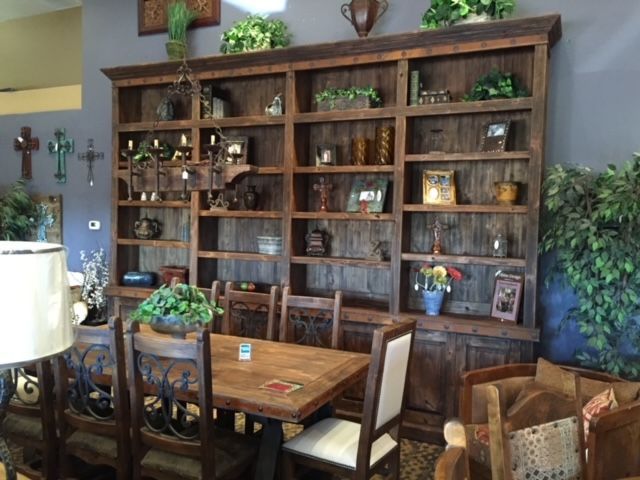 A room with a table and chairs and shelves