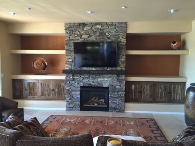 A living room with a fireplace and a flat screen television