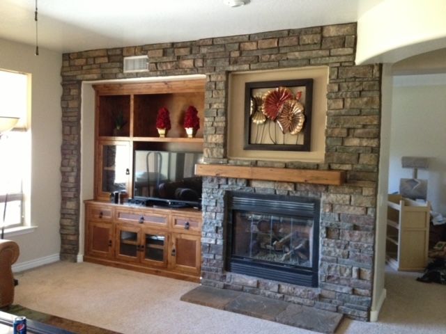 A living room with a fireplace and entertainment center