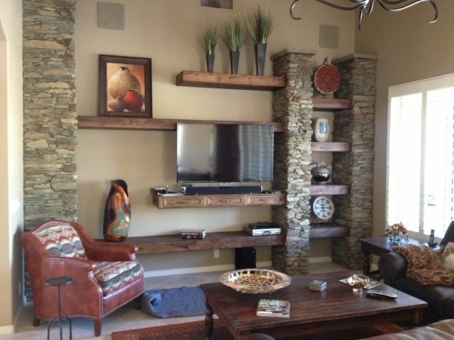 A living room with a flat screen television on the wall