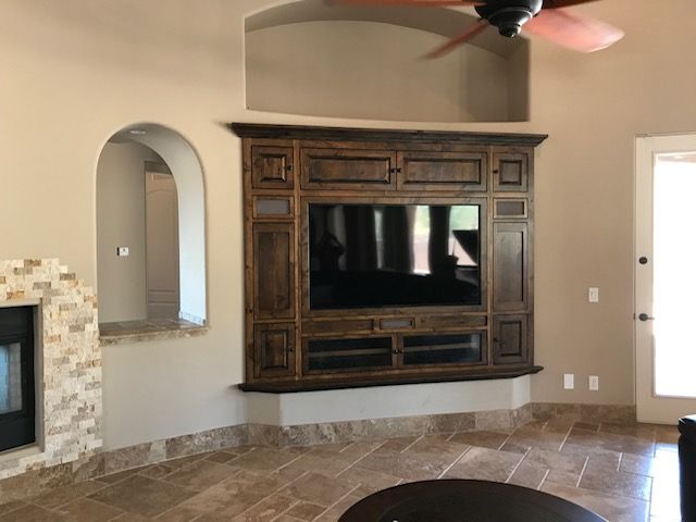 A living room with a fireplace and a flat screen television