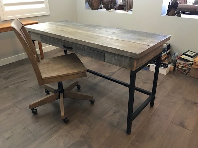 A wooden desk with a chair in a home office room