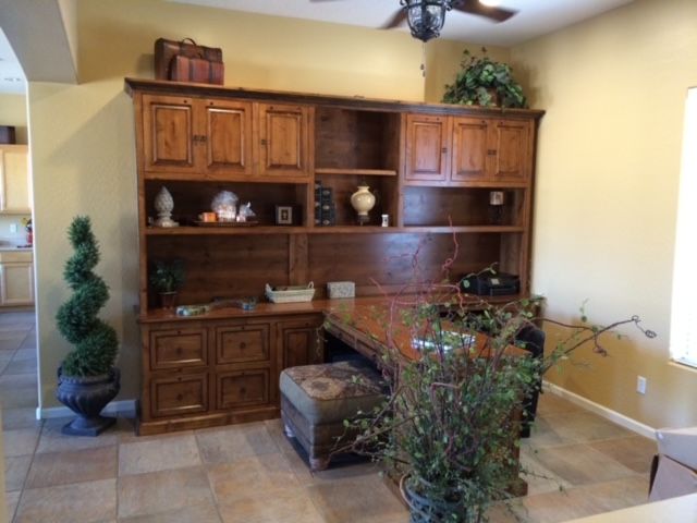 An elegant home office room with a desk and a ceiling fan