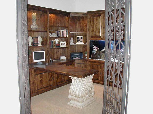 A home office room with a desk and a computer on it