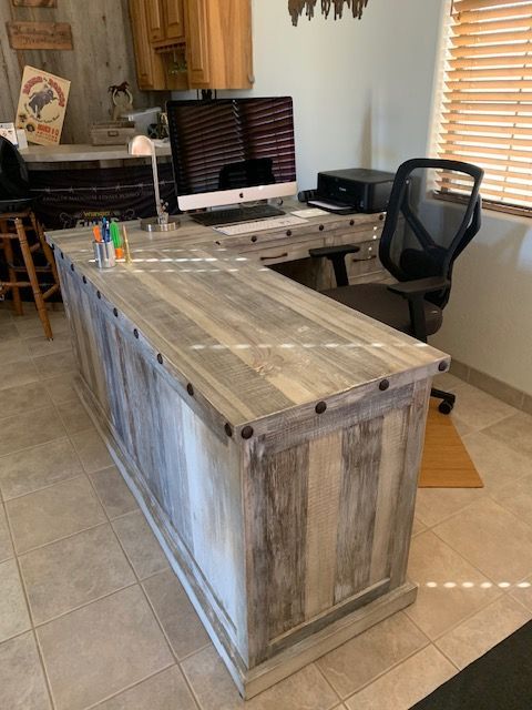 A wooden desk with a computer and a chair in a home office room