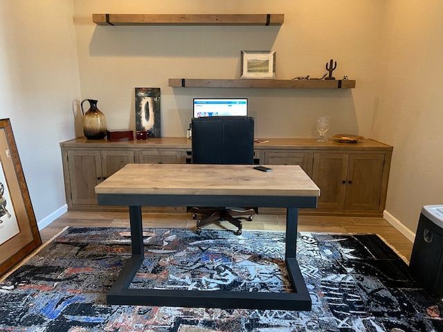 A home office with a desk and chair and a computer on the desk