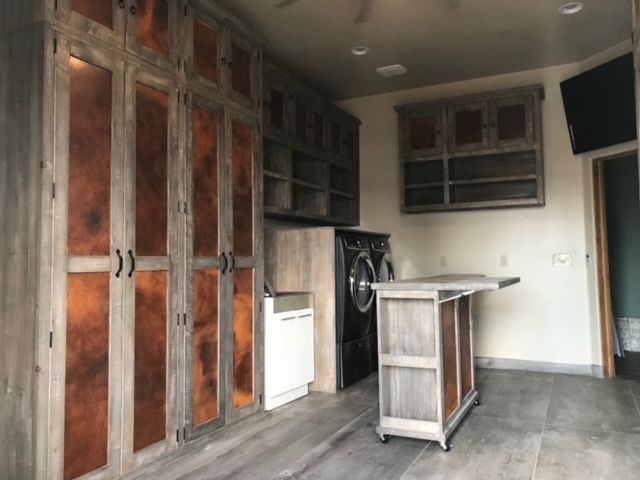 A laundry room with wooden cabinets and a washer and dryer