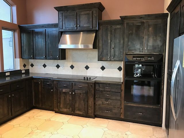A kitchen with stainless steel appliances and wooden cabinets