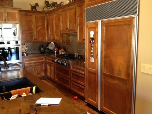 A kitchen with wooden cabinets and stainless steel appliances