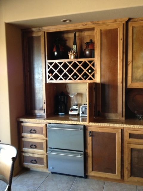 A kitchen with wooden cabinets