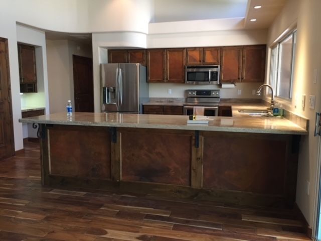 A kitchen with stainless steel appliances and wooden cabinets