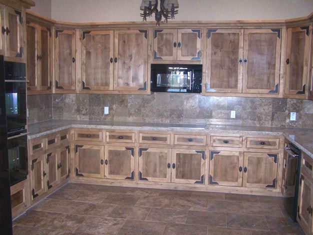 A kitchen with wooden cabinets and granite counter tops