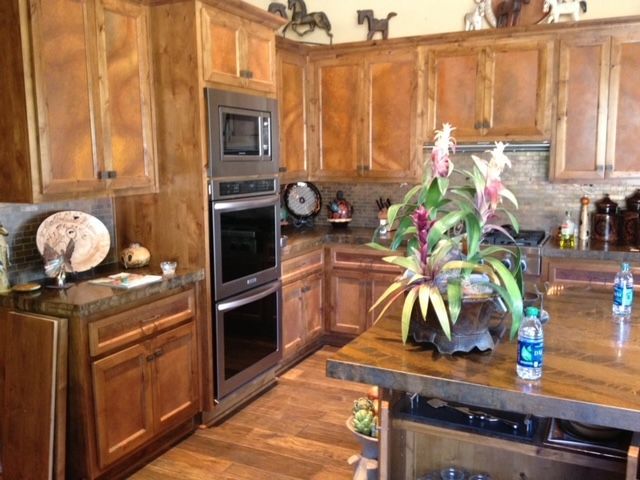 A kitchen with wooden cabinets and stainless steel appliances