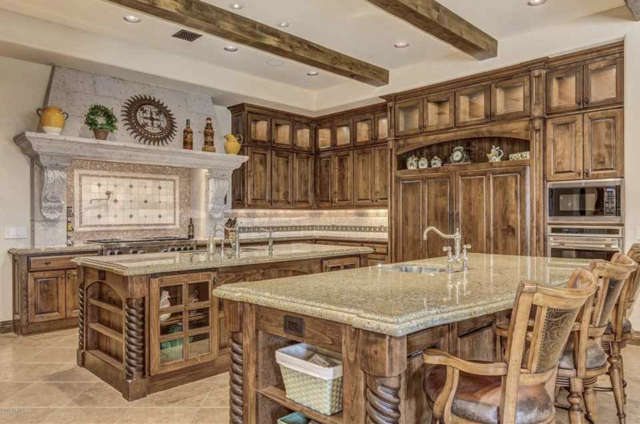 A kitchen with a large island in the middle and wooden cabinets