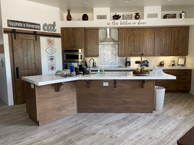 A kitchen with a large island and wooden cabinets