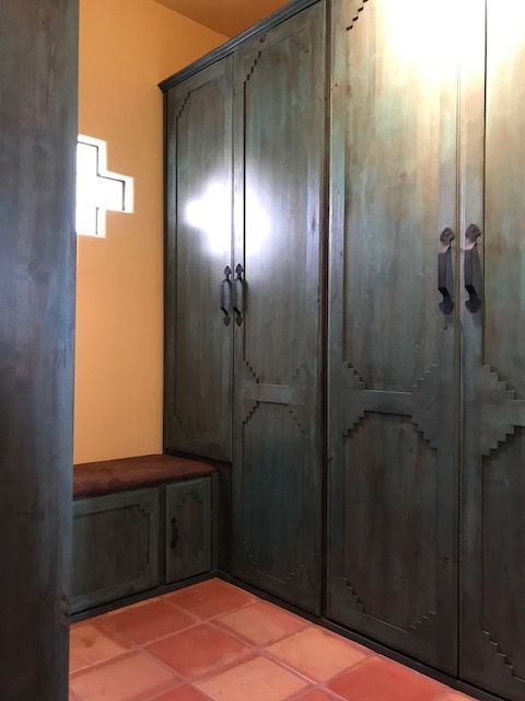 A room with lots of cabinets and a bench