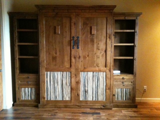 A large wooden Murphy bed with a striped design on the cabinets