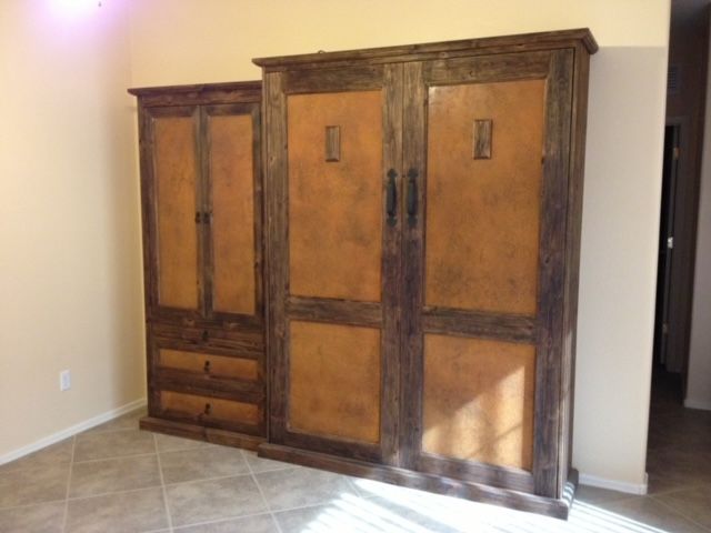 A bedroom with a large wooden Murphy bed