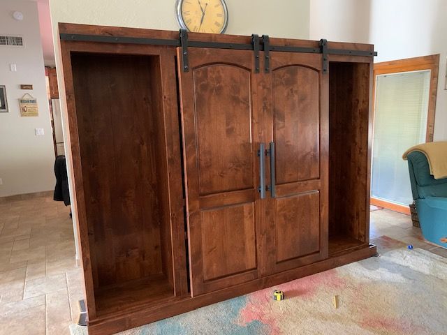 A large wooden Murphy bed with sliding doors