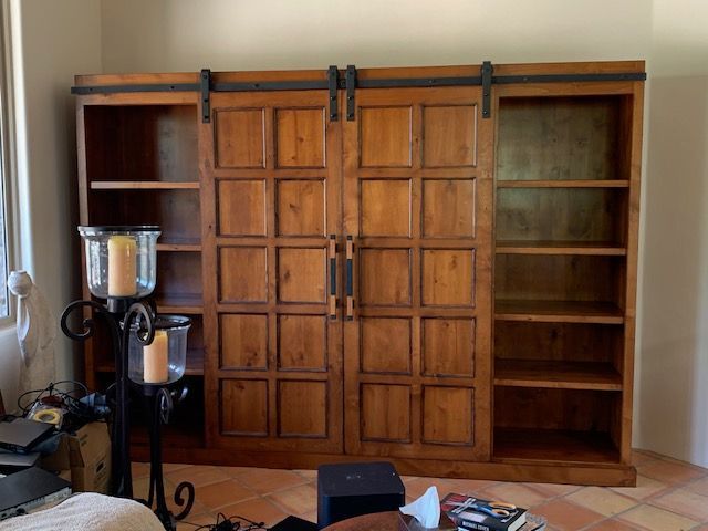 A large wooden Murphy bed with sliding doors